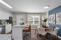 Kitchen and dining area with hardwood-style flooring
