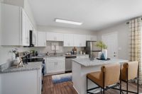 Kitchen with granite counters, stainless appliances, and modern cabinetry