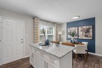Kitchen Island with granite counters and hardwood style flooring