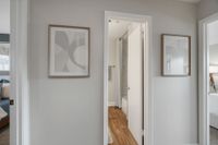 Hallway with hardwood-style flooring & great wall space
