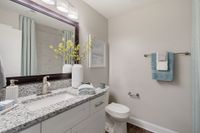 Bright bathroom with granite counters and bathtub