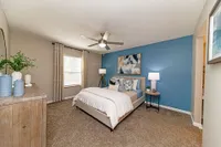 Cozy bedroom with carpet and ceiling fan
