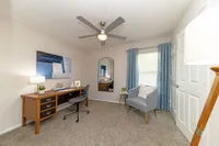 Cozy bedroom with carpet and ceiling fan