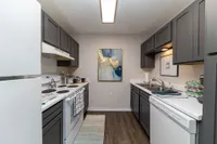 Kitchen with modern cabinetry & white appliance package