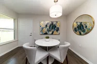 Dining area with hardwood-style flooring & built-in lighting