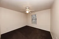 Cozy bedroom with carpet & ceiling fan
