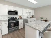 Kitchen with granite counters, stainless appliances, and modern cabinetry