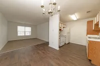 Dining + Kitchen area with hardwood-style flooring