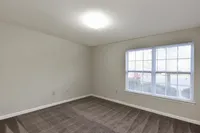 Bedroom with carpet & overhead lighting