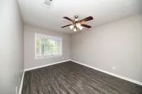 Bedroom with hardwood-style flooring and ceiling fan