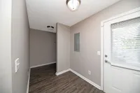 Hallway with hardwood-style flooring