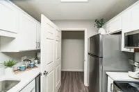 Kitchen with granite counters, modern cabinetry,  and stainless appliances