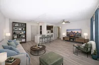 Modern open-concept living room featuring stylish decor, cozy seating area, spacious kitchen with bar seating, and natural light.