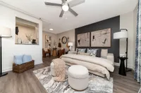 Chic modern living space with elegant decor, featuring abstract art, cozy seating, and contemporary design elements.