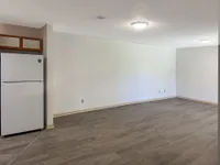 Living room with hardwood-style flooring & over-head lighting