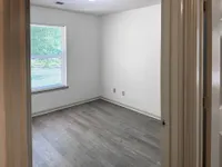 Bedroom with hardwood-style flooring & over-head lighting