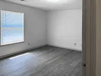 Bedroom with hardwood-style flooring