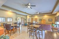 Elegant apartment interior with an open-plan living and dining area featuring stylish wooden furniture, large windows, and warm lighting.