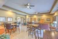 Inviting open-concept living area with elegant ceiling fans, cozy seating, and stylish dining furniture, perfect for entertaining.