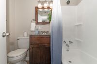 Bright bathroom with granite counters and bathtub