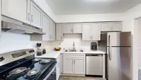 Kitchen with granite counters, modern cabinetry, and stainless appliances