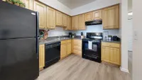 Kitchen with granite counters and black appliance package