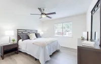 Bedroom with hardwood-style flooring & ceiling fan