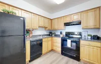 Kitchen with granite counters and black appliance package