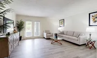 Spacious living room with hardwood-style flooring