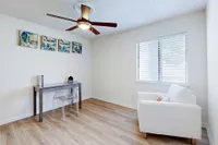 Bedroom with hardwood-style flooring & ceiling fan
