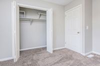 Bedroom with carpet and generous closet space