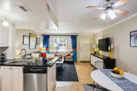 Contemporary living space with an open-concept kitchen, stylish seating, and vibrant decor, perfect for modern living.