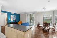 Large livingspace with large dining window and sliding pation door to create an open and bright space