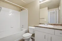 Classic bathroom with shower tub combo and sink with underneath storage