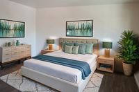 Large bedroom with queen bed and modern furnishings