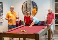 Arcadia Gardens seniors playing pool with friends