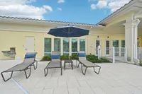 Inviting outdoor space with elegant lounge chairs, a stylish umbrella, and scenic views, perfect for relaxation and leisure.