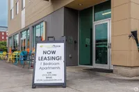 Welcoming entrance to Fayette Place Apartments with leasing sign for vibrant 1-bedroom units, highlighting modern city living.