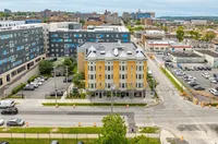 Charming urban apartment building with unique turret design, surrounded by vibrant cityscape and conveniently close to local amenities.