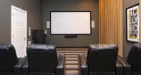 Luxurious home theater with comfortable leather seating, large screen, and stylish decor.