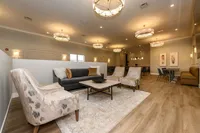 Elegant communal lounge with stylish seating, warm lighting, and a cozy atmosphere, perfect for relaxation and socializing.
