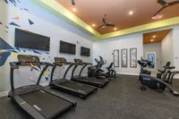 Modern fitness center with state-of-the-art treadmills, ellipticals, and bikes, perfect for an invigorating workout experience.