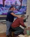 Relaxing spa experience with a professional massage in a cozy setting, featuring a soothing fireplace video.