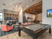 Clubhouse with pool table, lounge area, and TVs