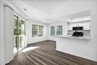 Renovated Apartment - Wood-plank flooring, sliding doors, ceiling fan in living area at  | The Residence at Turnberry | Columbus Apartments