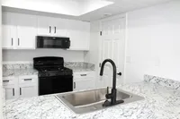 Kitchen - countertops, sink, cabinetry, stove, microwave  | The Residence at Turnberry | Columbus Apartments
