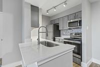 Kitchen w/ Stylish Tile Backsplash Renata on Fredericksburg Apartments, San Antonio, Texas