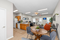 Inviting open-plan living space with a cozy dining area, modern kitchen, and stylish seating, perfect for relaxation and entertainment.