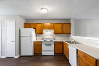 Charming kitchen with warm wooden cabinets, sleek countertops, and modern appliances, perfect for any culinary enthusiast.