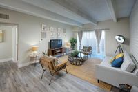 Chic living room with modern furnishings, bright natural light, and stylish decor, perfect for entertaining.